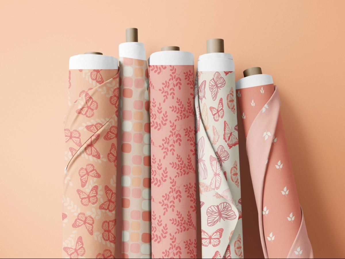 Five rolls of fabric featuring the Pantone Color of the Year, Peach Fuzz