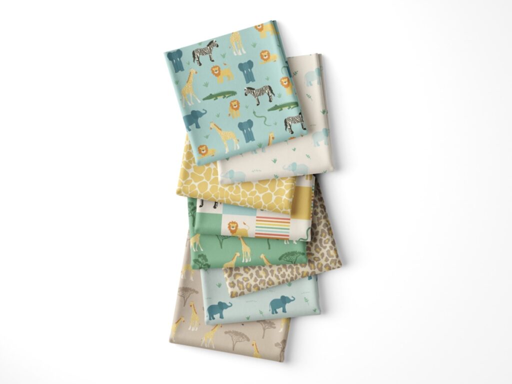 Photograph of eight folded fabric swatches of the Wild Safari Adventure fabric collection