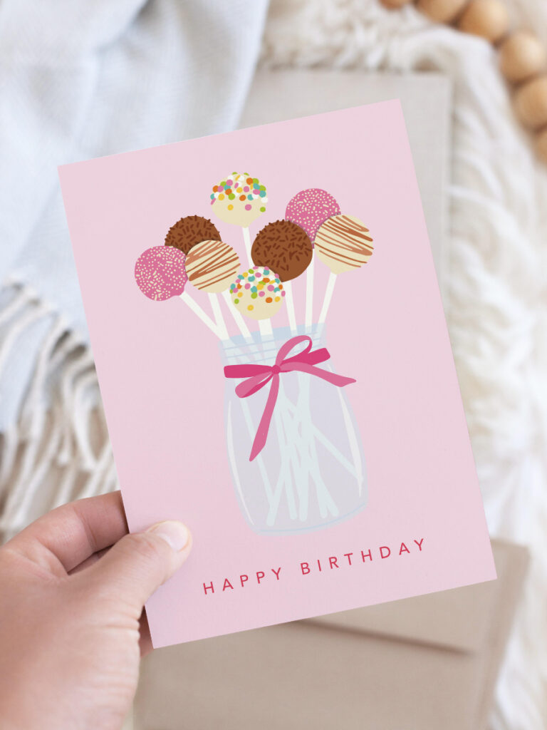 Birthday card featuring an illustration of a class mason jar tied with a pink ribbon, filled with colorful decorated cake pops.